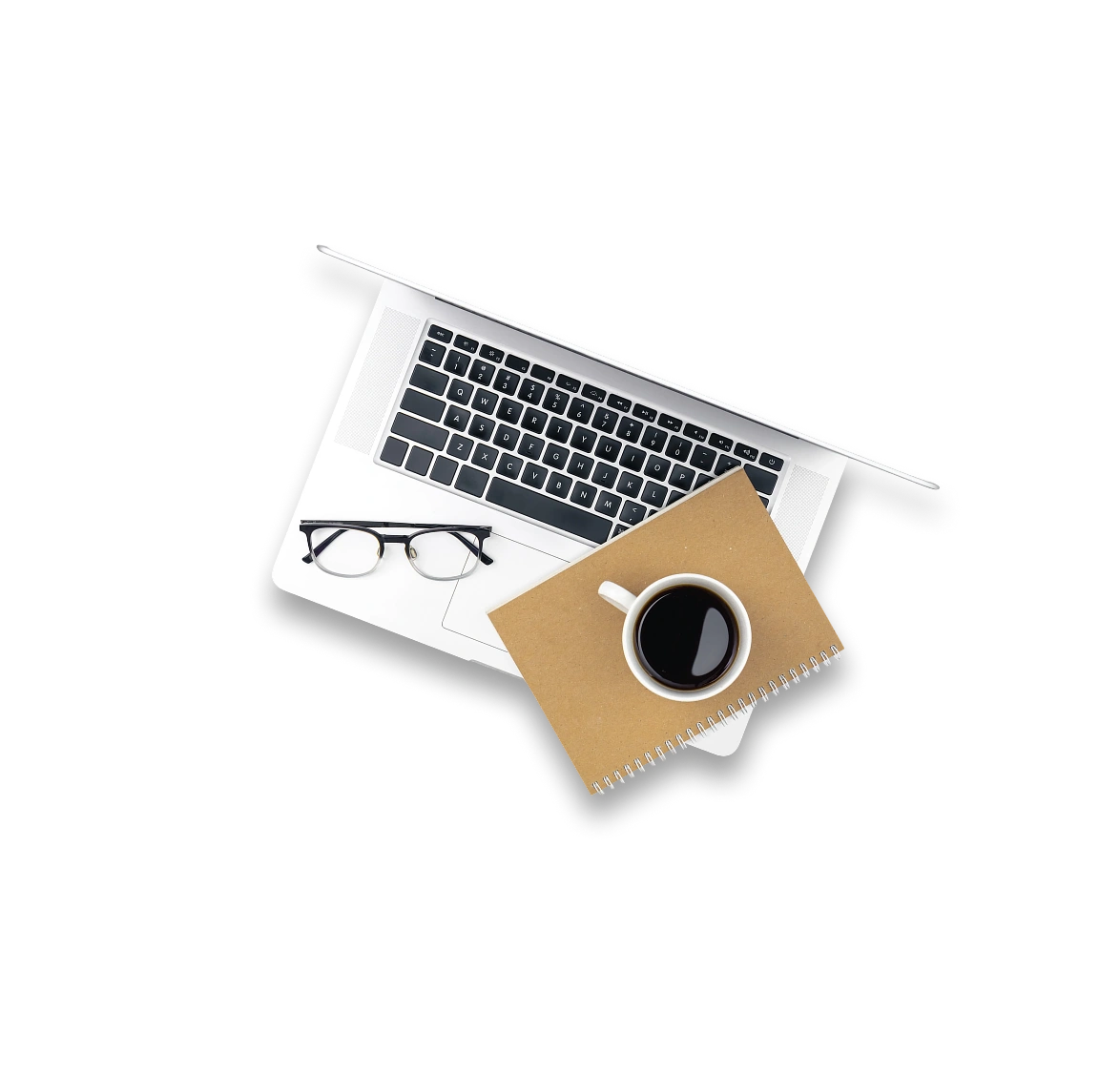 Laptop with glasses, notebook, and coffee cup arranged on a desk in a top view